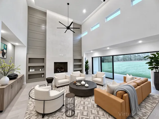 a large kitchen with kitchen island a sink dishwasher stove and white cabinets with wooden floor