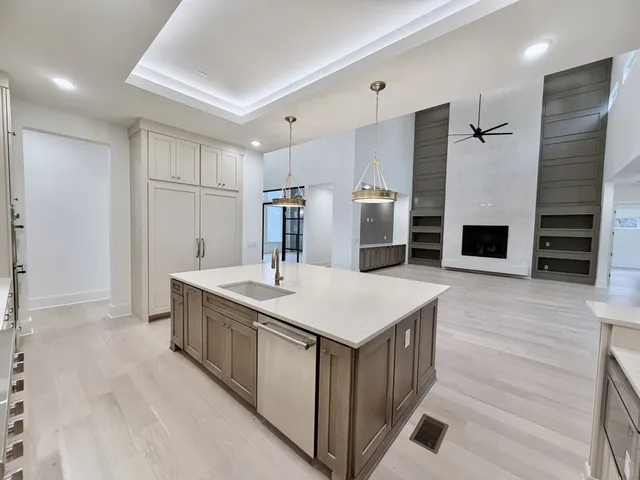 a living room with furniture a fireplace and a potted plant