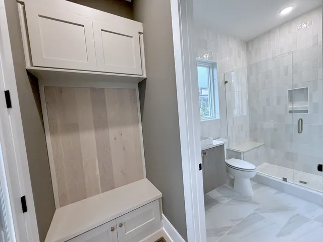 a bathroom with a toilet sink and mirror