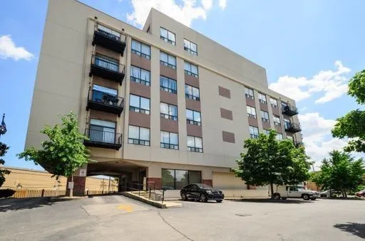 a view of building with parking area