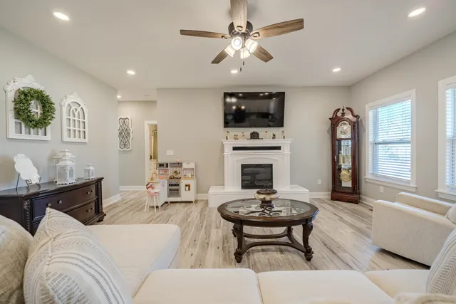 a living room with furniture a fireplace and a flat screen tv
