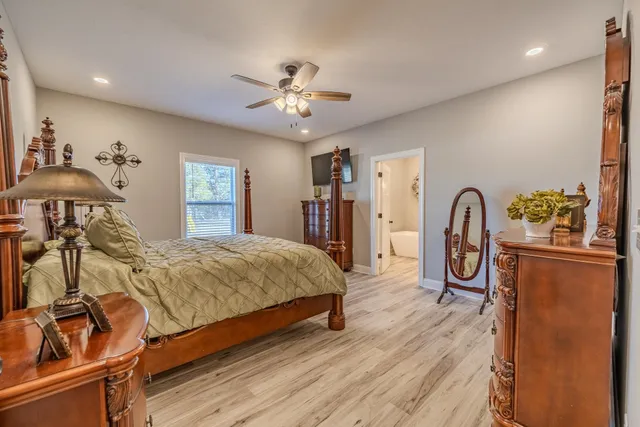 a bedroom with a bed and wooden floor