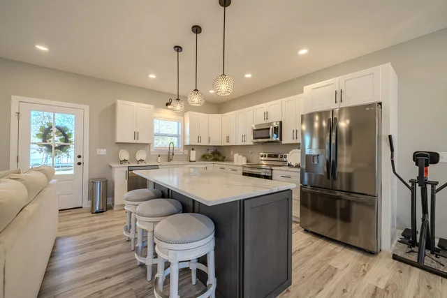a kitchen with appliances a sink and cabinets