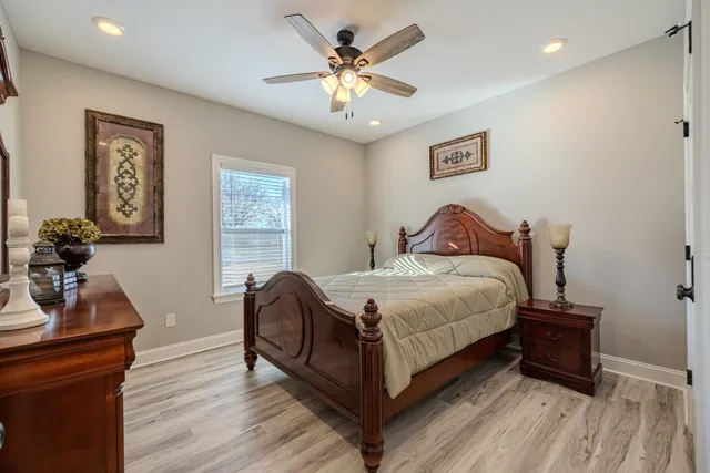 a bathroom with a granite countertop sink toilet and a mirror