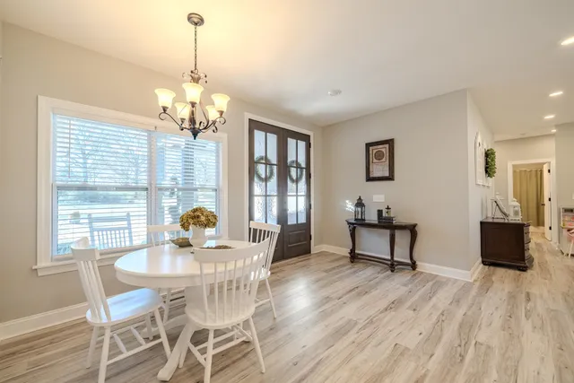 a large kitchen with kitchen island a large counter top space a sink stainless steel appliances and cabinets