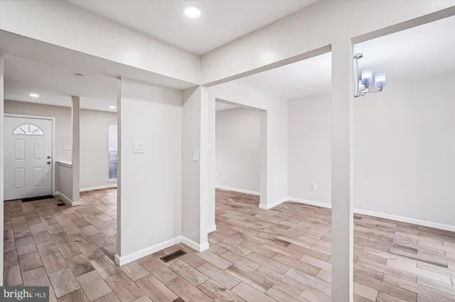 a view of a hallway with wooden floor