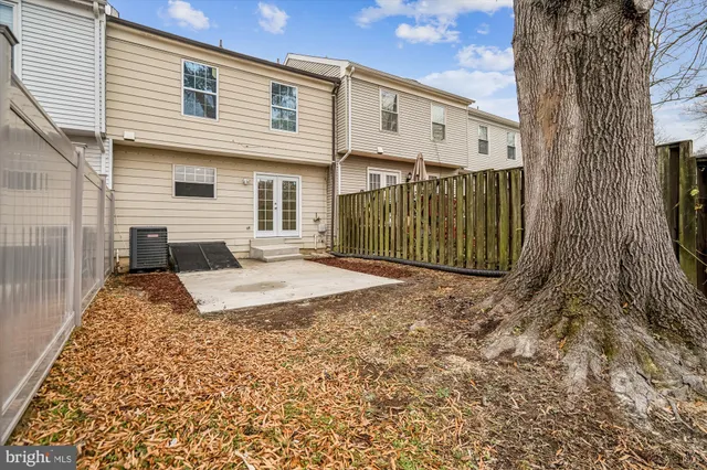 a view of a house with a wooden fence