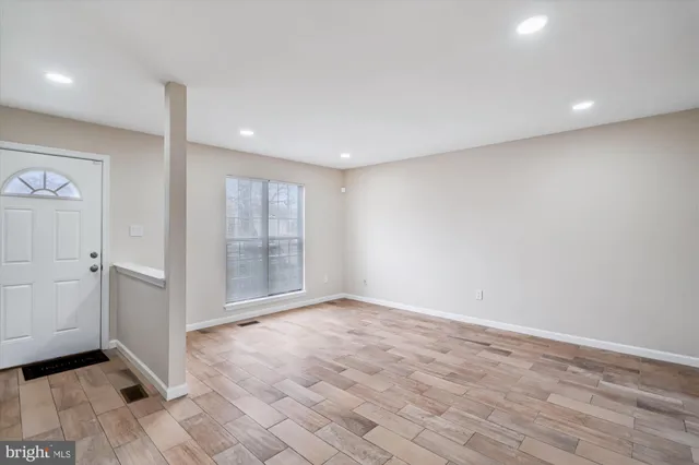 wooden floor in an empty room with a window
