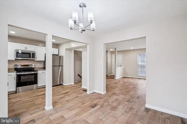a view of a kitchen with a sink and stainless steel appliances