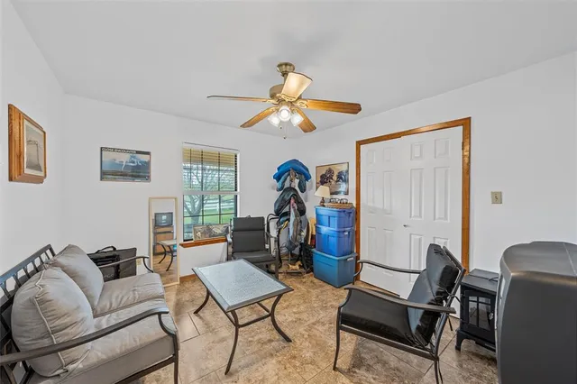 a living room with furniture a chandelier and a window