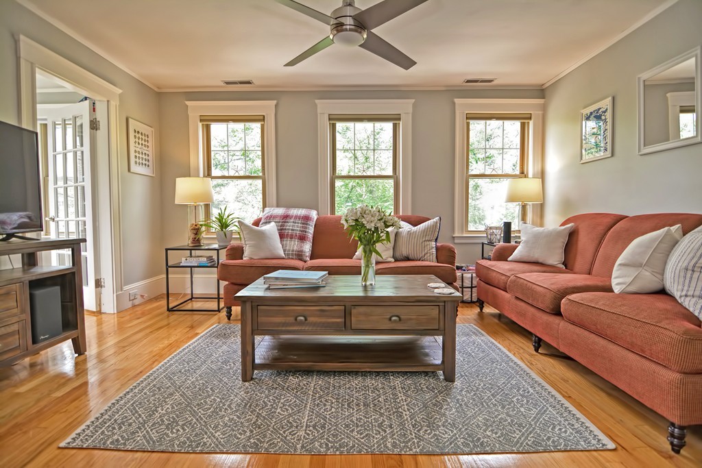 34 Bradford Road, Unit 2 Watertown, MA 02472 - Photo 19 of 39 a living room with furniture a rug wooden floor and a large window