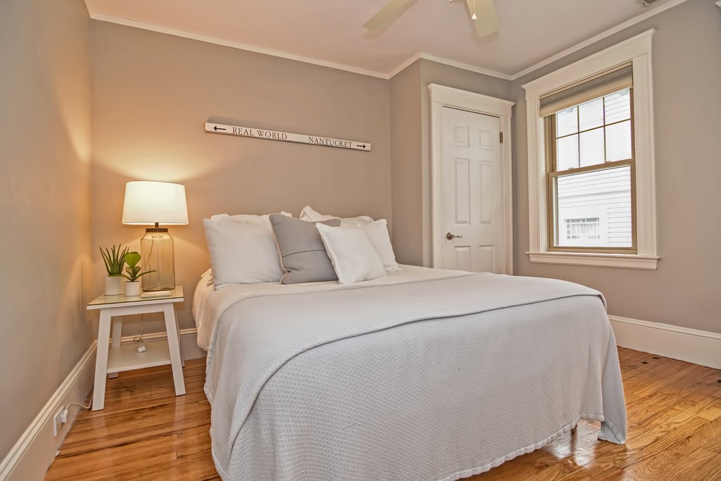 34 Bradford Road, Unit 2 Watertown, MA 02472 - Photo 25 of 39 a bedroom with a bed and a window