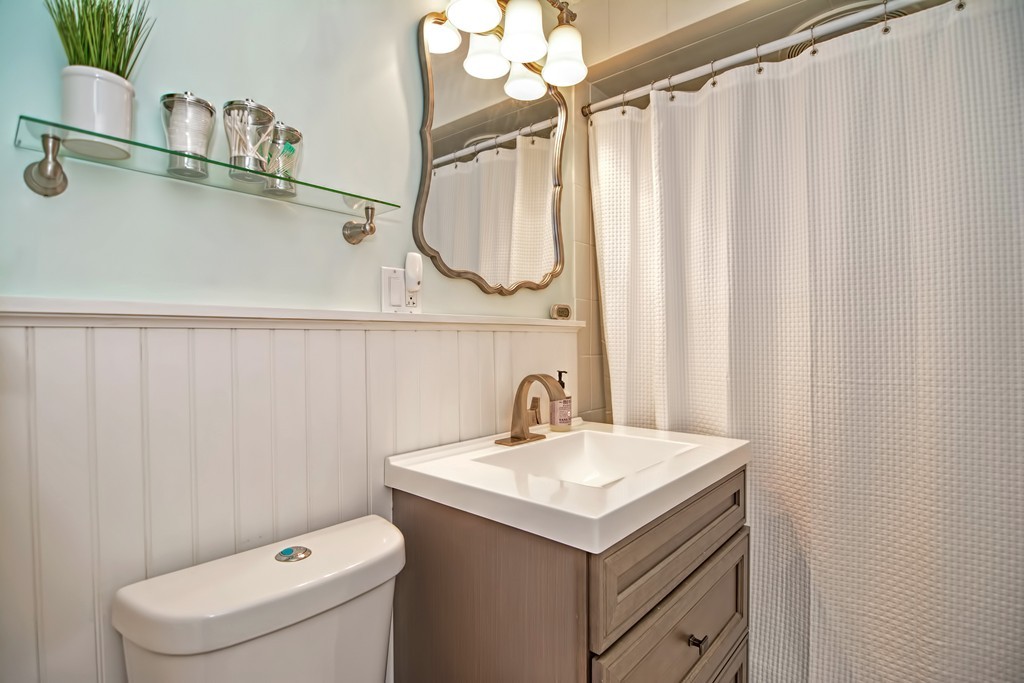 34 Bradford Road, Unit 2 Watertown, MA 02472 - Photo 31 of 39 a bathroom with a sink a toilet and a mirror