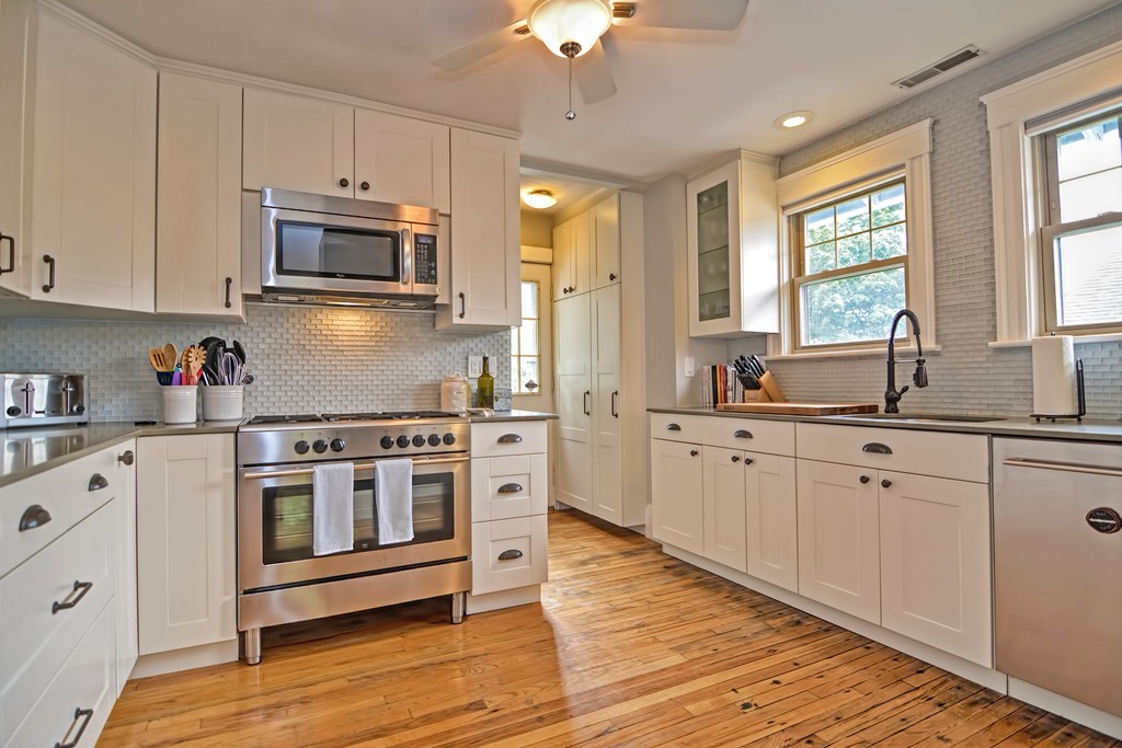 34 Bradford Road, Unit 2 Watertown, MA 02472 - Photo 4 of 39 a kitchen with stainless steel appliances white cabinets a sink and a stove