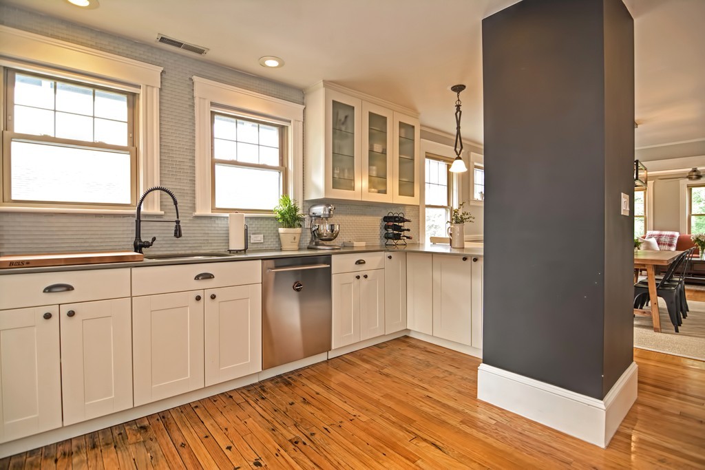 34 Bradford Road, Unit 2 Watertown, MA 02472 - Photo 6 of 39 a kitchen with granite countertop a stove a sink and wooden floor