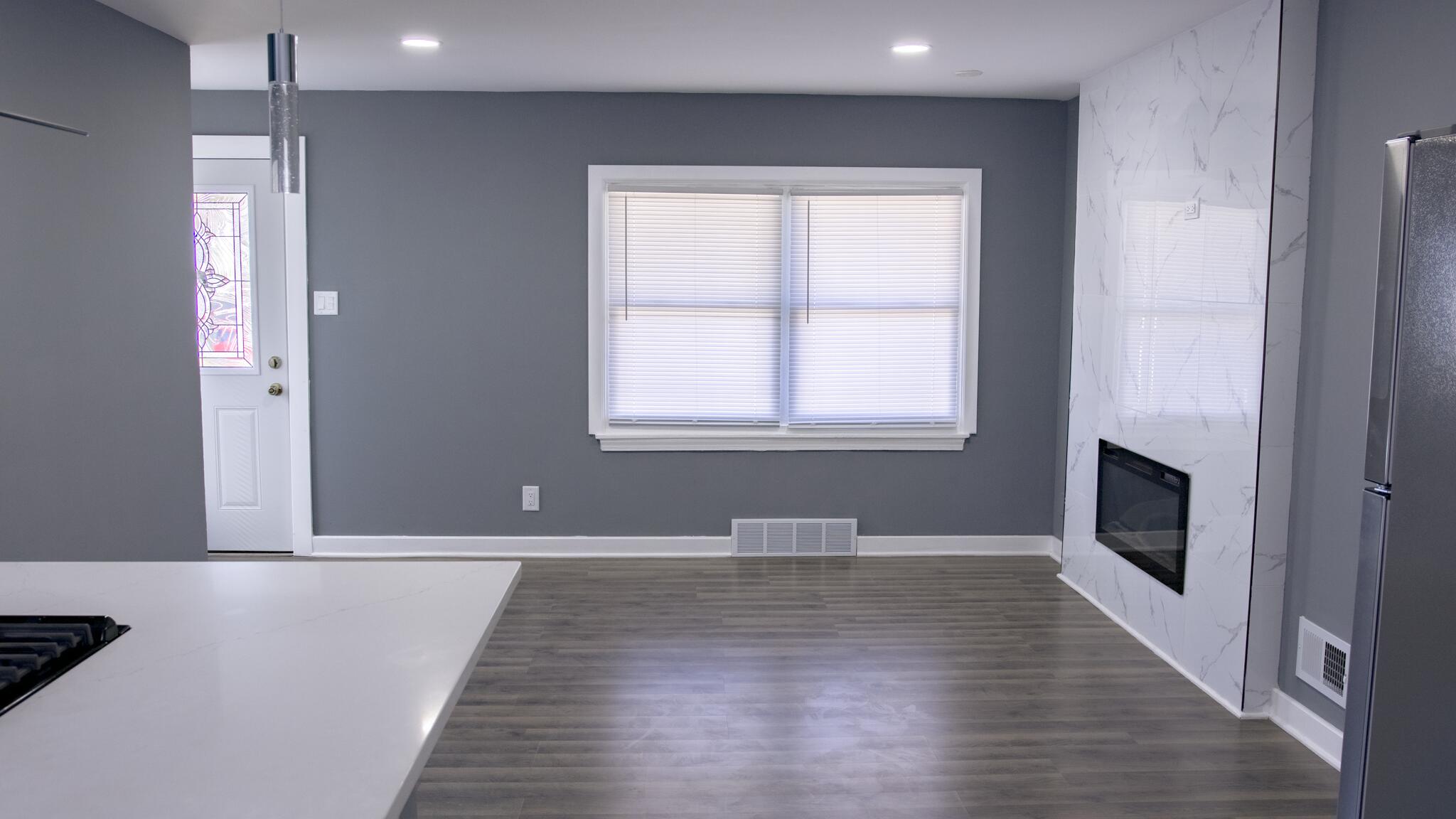 418 Dallas Street Gary, IN 46406 - Photo 11 of 22 a view of an empty room with wooden floor and a window