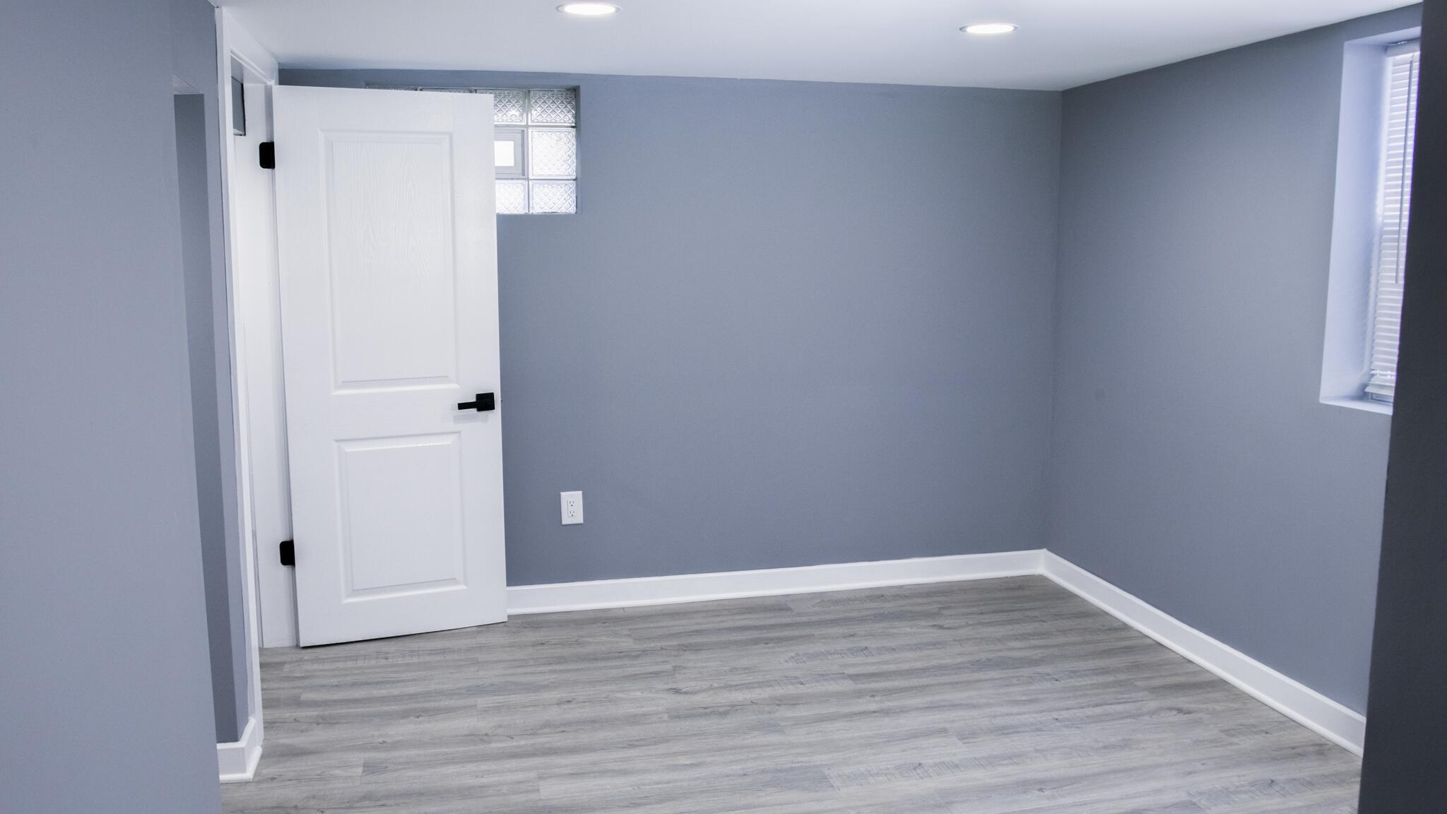 418 Dallas Street Gary, IN 46406 - Photo 5 of 22 a view of an empty room with wooden floor and window