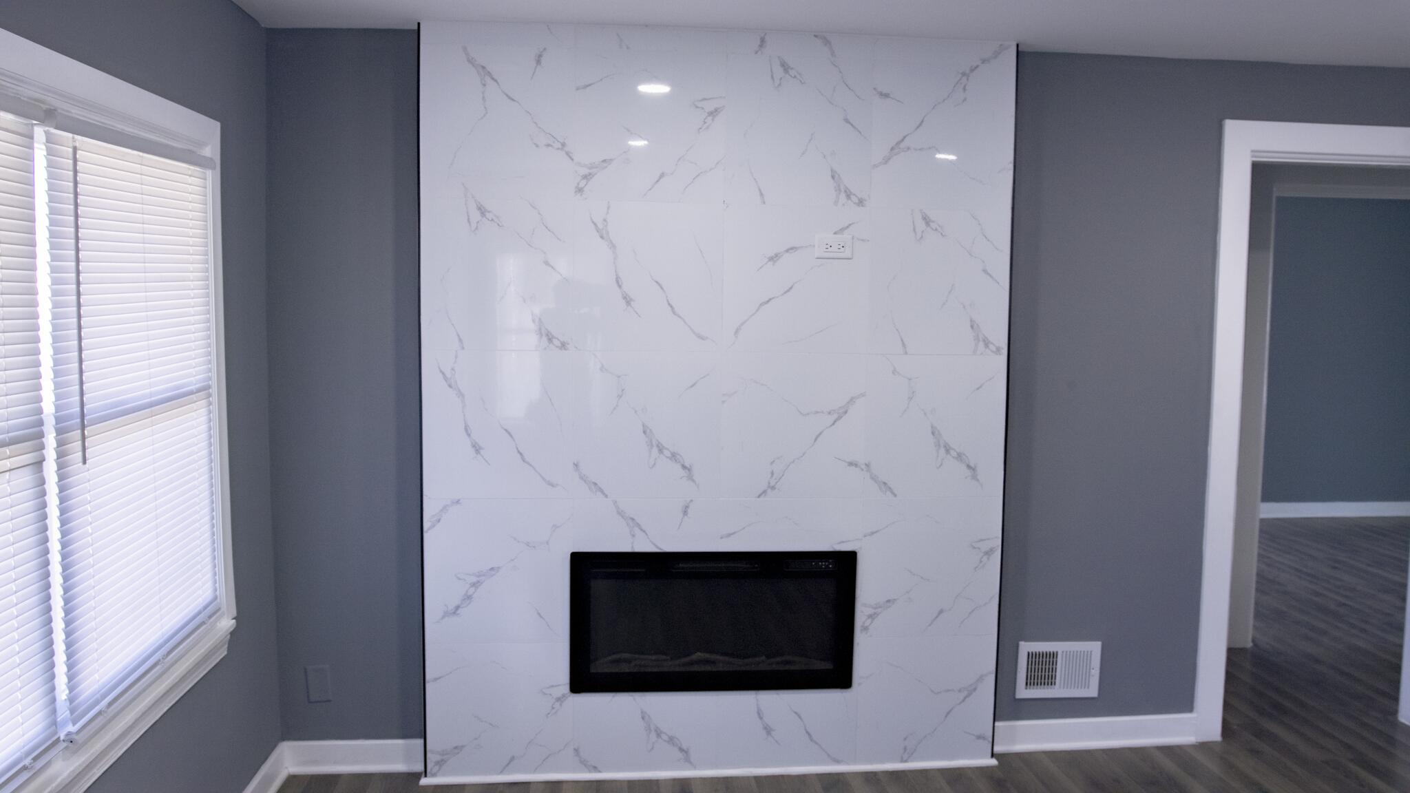 418 Dallas Street Gary, IN 46406 - Photo 6 of 22 a living room with a fireplace and a flat screen tv