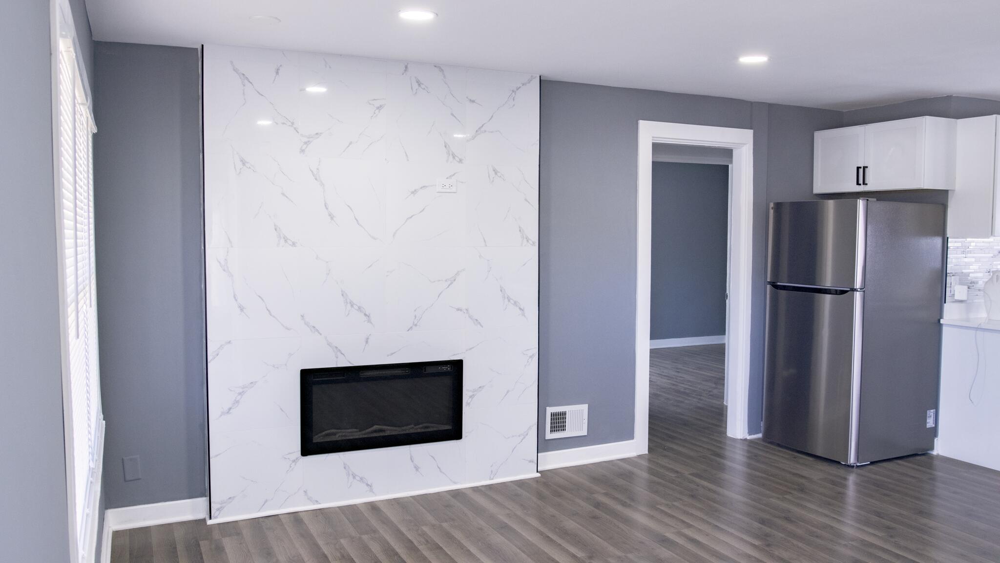 418 Dallas Street Gary, IN 46406 - Photo 10 of 22 a view of a livingroom with wooden floor and a fireplace