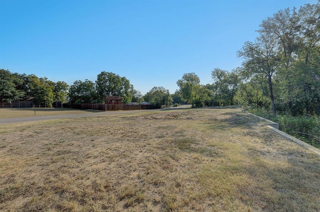 6724 Starbuck Drive Dallas, TX 75252 - Photo 20 of 30 a view of a field with trees in the background