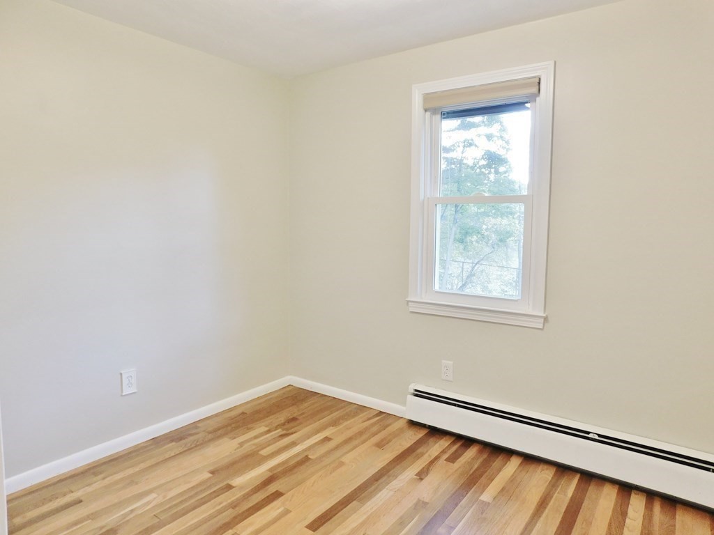 214 Hartwick Street Springfield, MA 01108 - Photo 17 of 25 a view of a room with wooden floor and a window