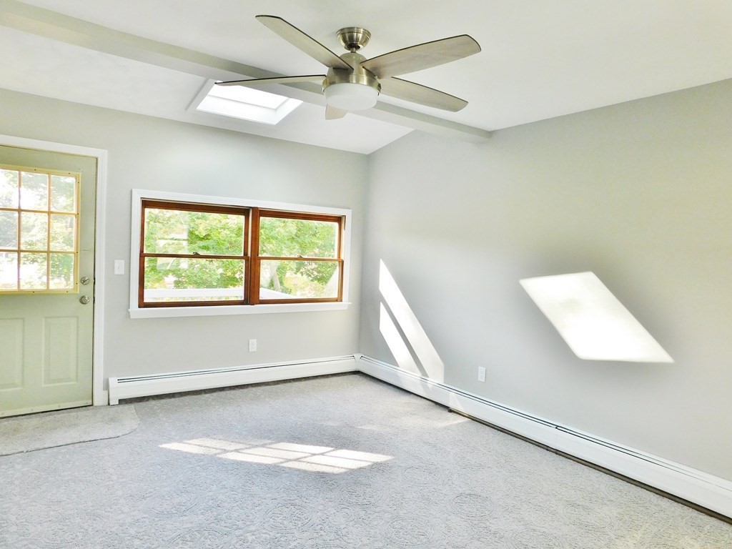 214 Hartwick Street Springfield, MA 01108 - Photo 3 of 25 an empty room with windows and fan
