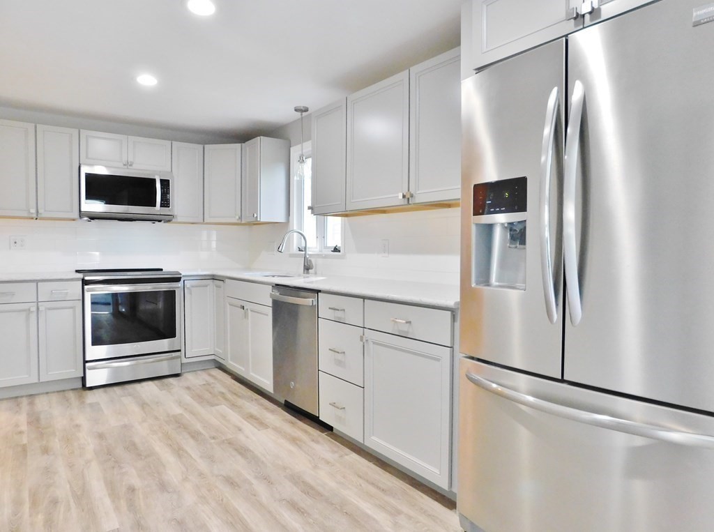 214 Hartwick Street Springfield, MA 01108 - Photo 6 of 25 a kitchen with stainless steel appliances a refrigerator sink and microwave