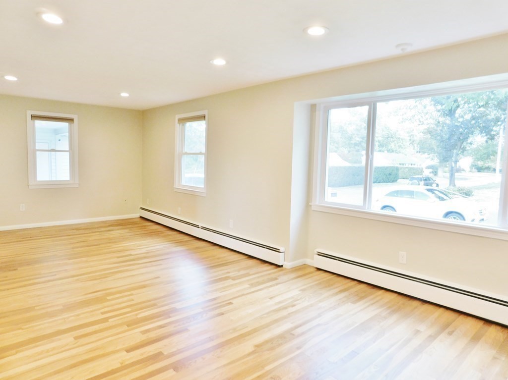 214 Hartwick Street Springfield, MA 01108 - Photo 7 of 25 a view of an empty room with wooden floor and a window