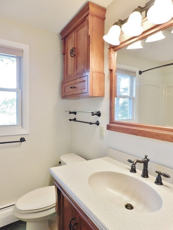 214 Hartwick Street Springfield, MA 01108 - Photo 10 of 25 a bathroom with a sink a toilet and mirror