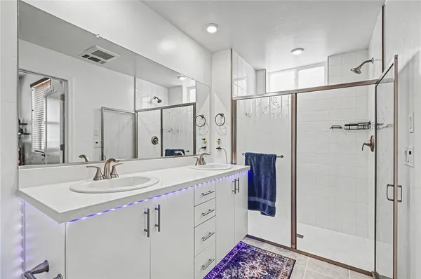 a bathroom with a sink double vanity and a mirror