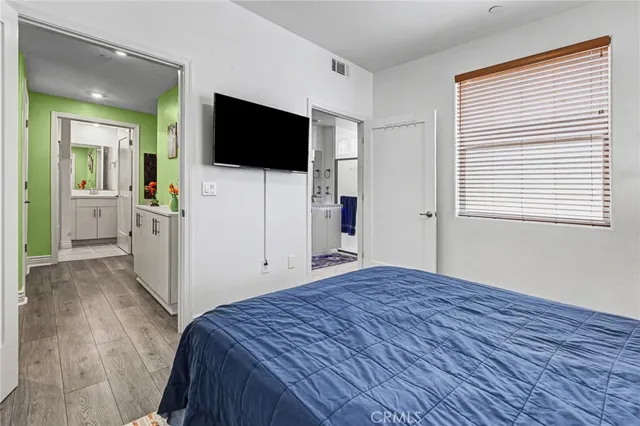 a bedroom with a bed and a flat screen tv
