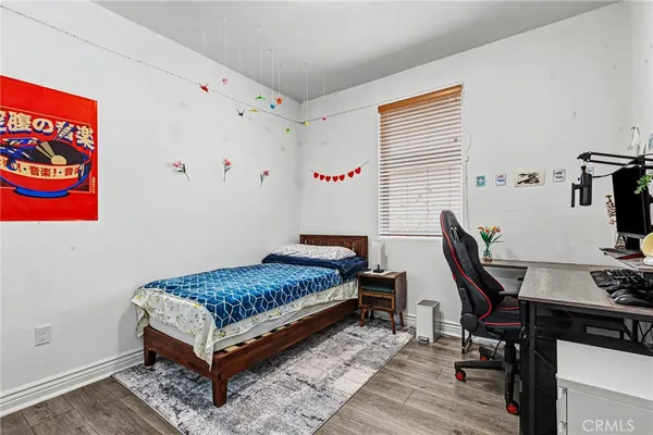 a bedroom with a bed and a desk in it