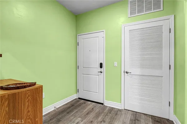 a view of a hallway with wooden floor