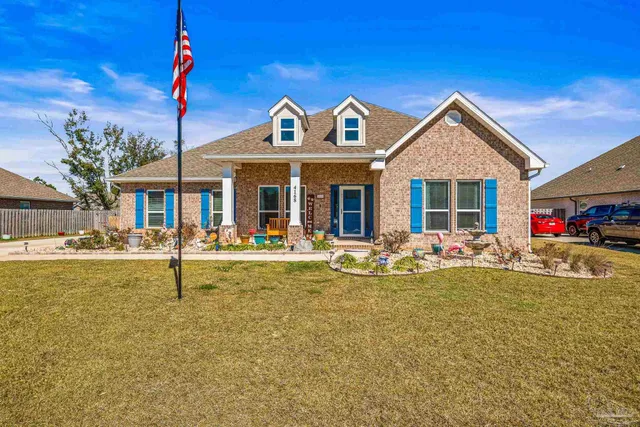 a view of a house with swimming pool and a table and chairs