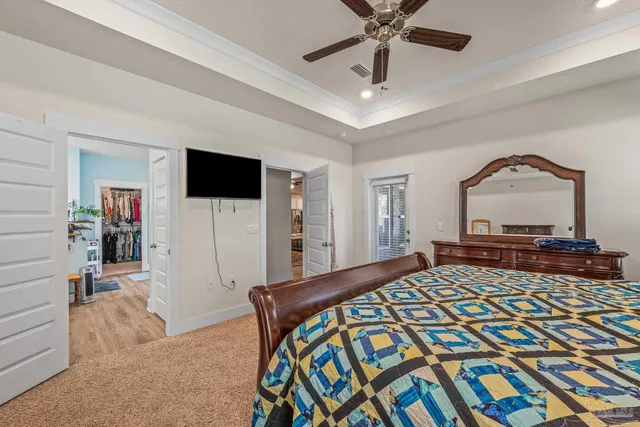 a large kitchen with stainless steel appliances refrigerator a stove and wooden floor