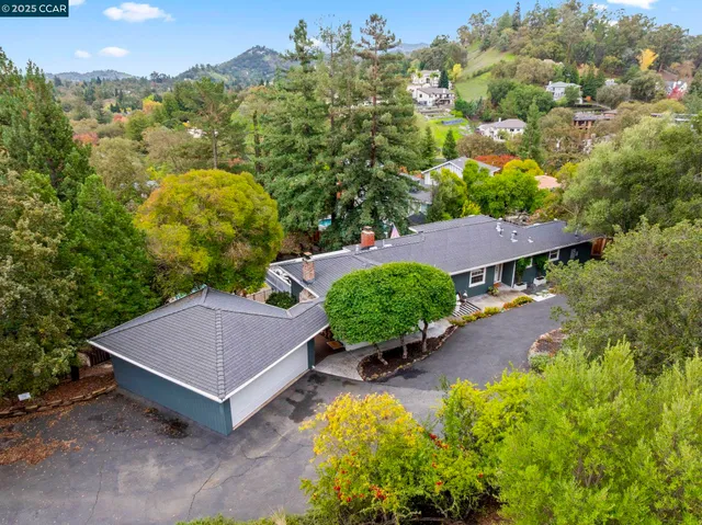 a view of a house with a yard and sitting area