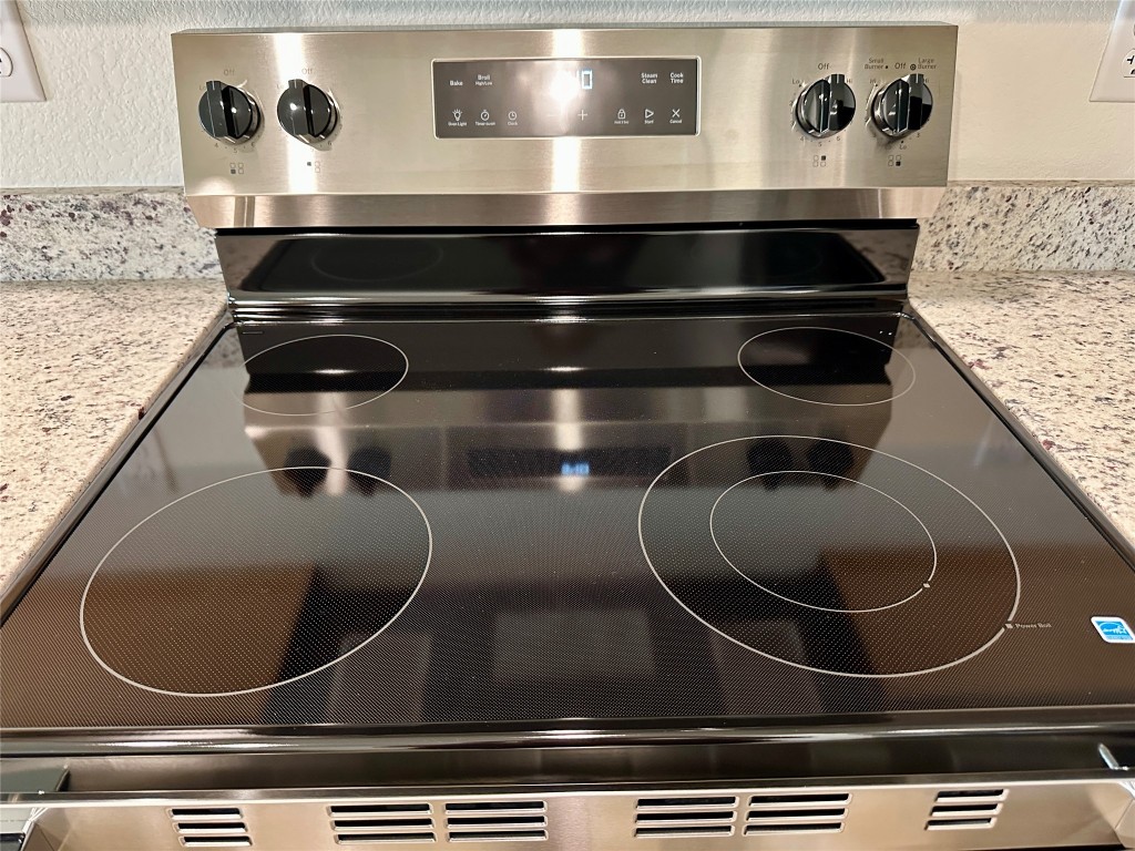2913 Quail Rdg Lane, Unit A Temple, TX 76501 - Photo 11 of 19 Kitchen view of light stone counters and stainless steel electric range oven