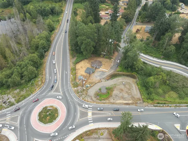 an aerial view of a house with garden space and lake view