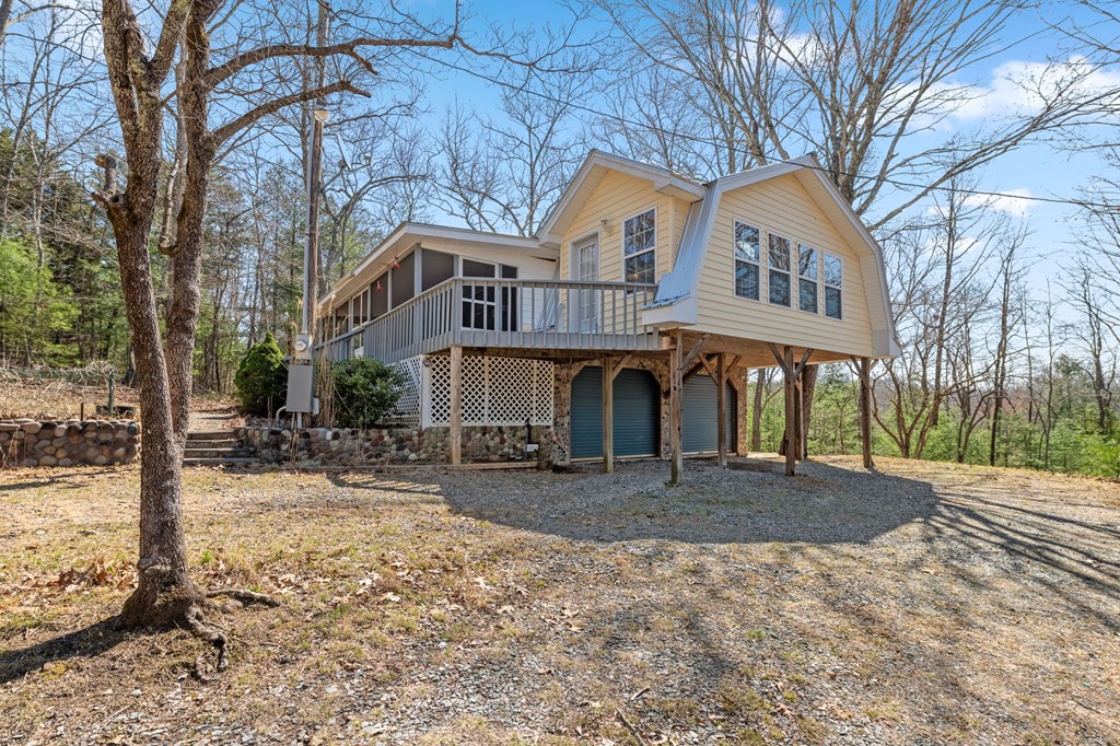 1262 Maple Grove Road Morganton, GA 30560 - Photo 15 of 68 a front view of a house with large trees and covered with snow