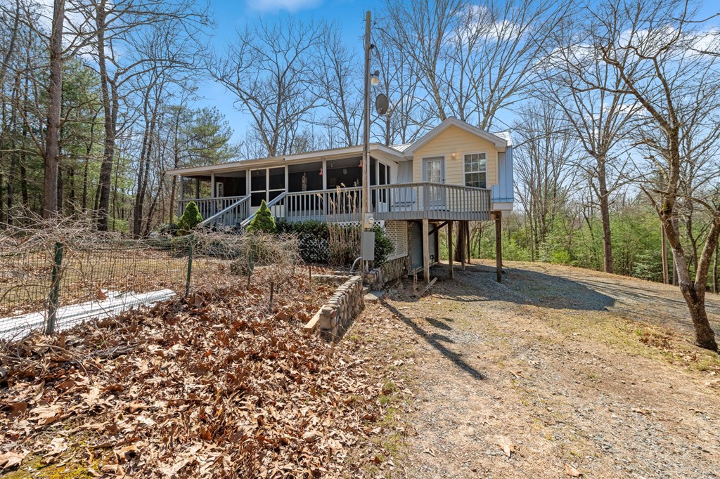 1262 Maple Grove Road Morganton, GA 30560 - Photo 18 of 68 a front view of a house with a yard and potted plants
