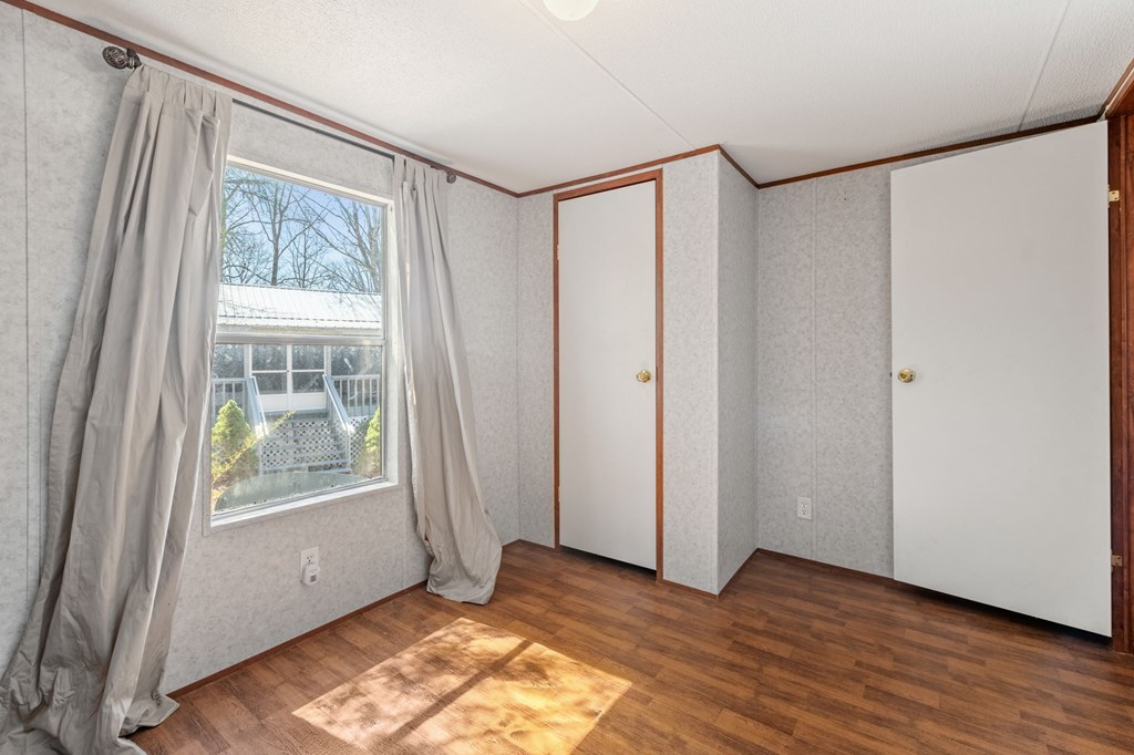 1262 Maple Grove Road Morganton, GA 30560 - Photo 47 of 68 a view of an empty room with wooden floor and a window