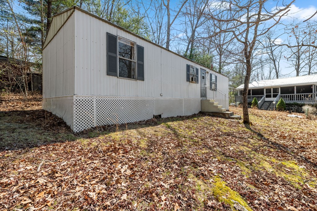 1262 Maple Grove Road Morganton, GA 30560 - Photo 48 of 68 a backyard of a house with wooden fence and large trees