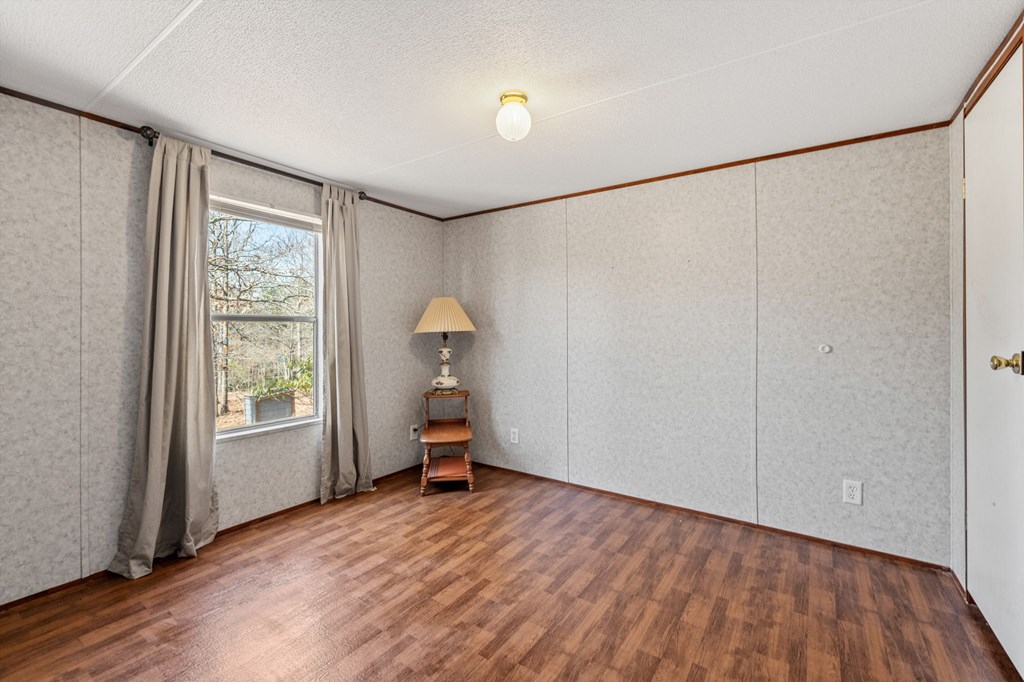 1262 Maple Grove Road Morganton, GA 30560 - Photo 49 of 68 a view of empty room with wooden floor and fan