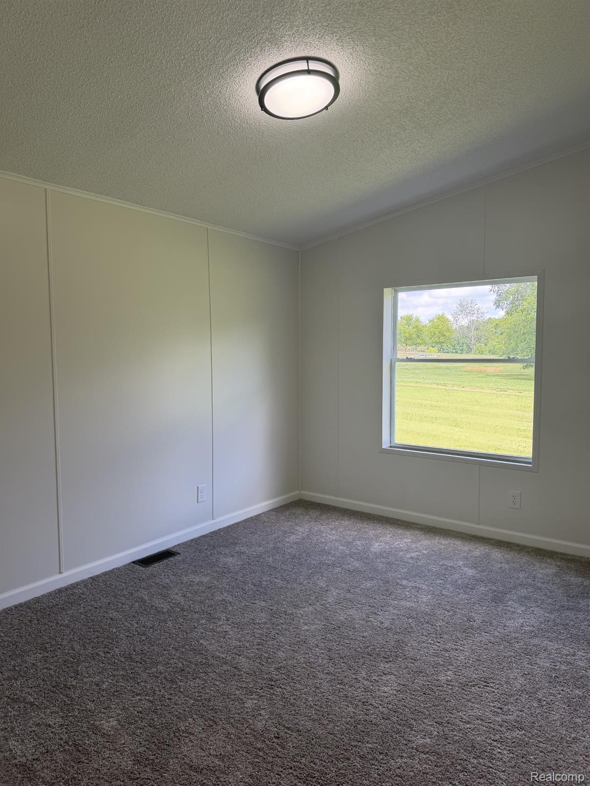 3586 Columbiaville Road Columbiaville, MI 48421 - Photo 10 of 10 Carpeted room featuring a single window, white baseboards, and a flush-mount ceiling light fixture