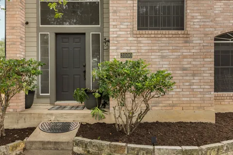 a view of a house with a potted plant