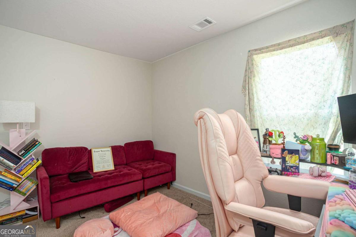 653 Meadows Farm Way Monroe, GA 30655 - Photo 30 of 34 a living room with furniture a couch and a window