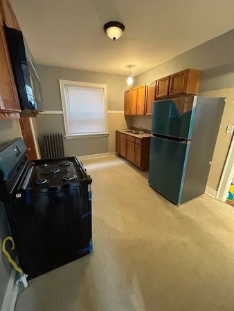 a kitchen with refrigerator and window