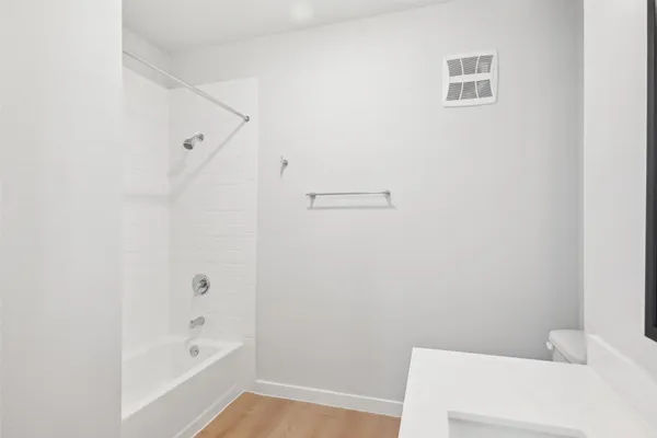 a bathroom with a bathtub and shower