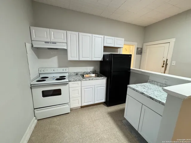 a kitchen with a white cabinets and white appliances