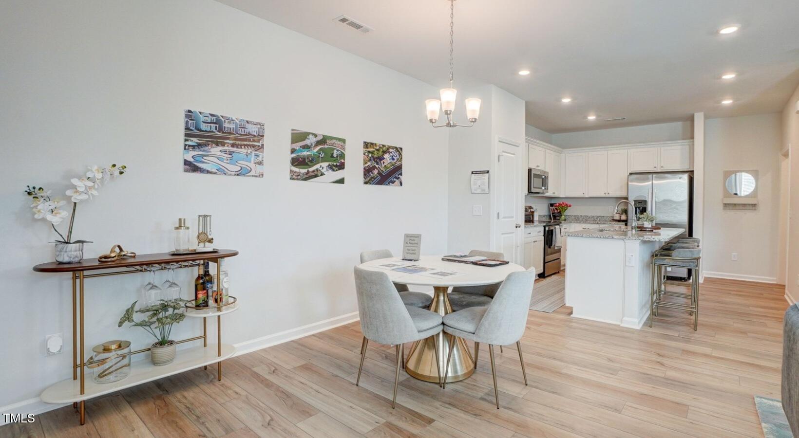 101 Decatur Drive, Unit WATSONIA Raleigh, NC 27603 - Photo 14 of 24 a view of a dining room with furniture and wooden floor